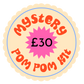 Round label with 'Mystery Pom Pom Kit' text and price on a white background
